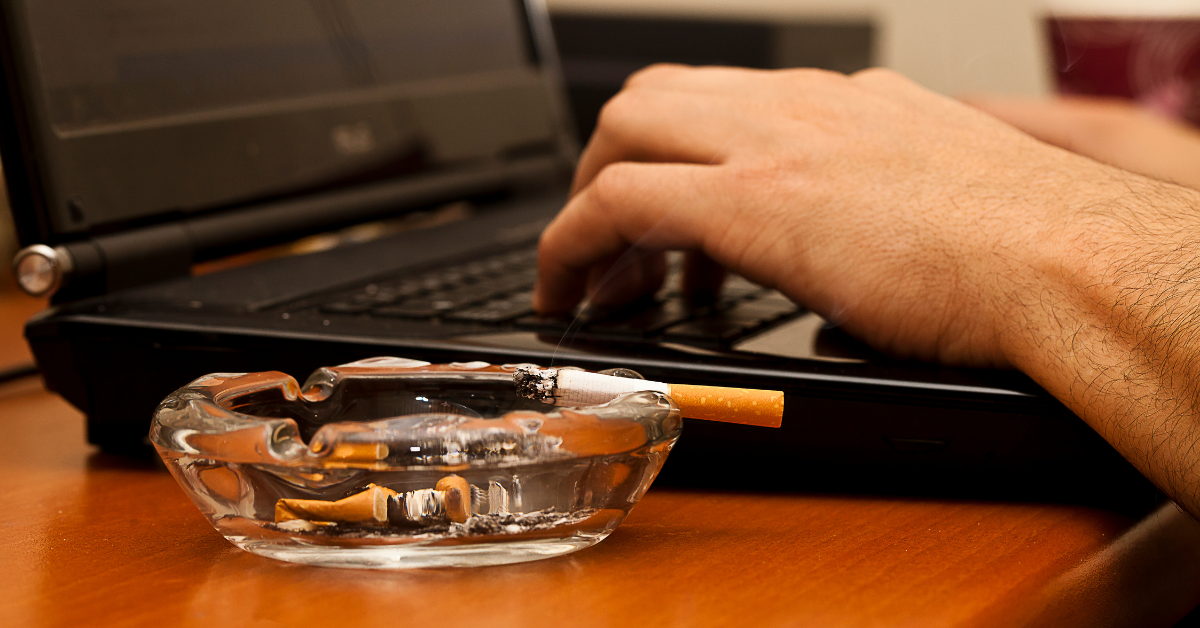 A man using a laptop and smoking cigarettes what is considered a bad habit in recovery