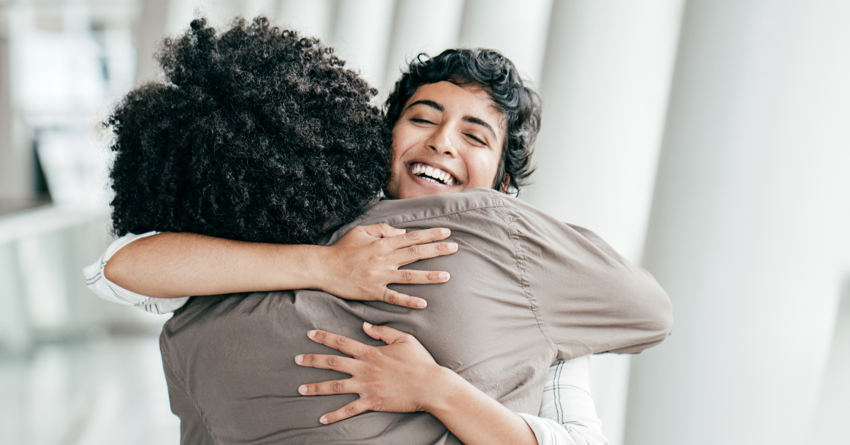A mother and her daughter embracing in a hallway as a symbol of forgiveness in addiction recovery.