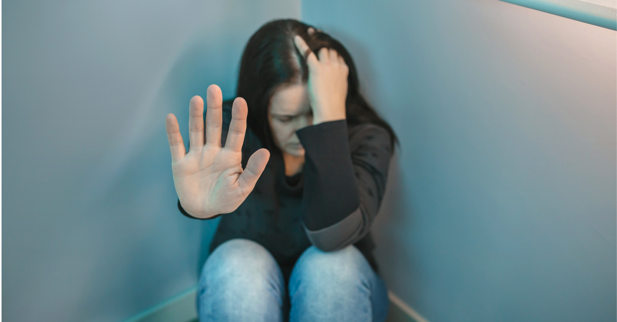 A girl sitting on the floor with her hand on her face, contemplating what to do when rehab doesn't work.