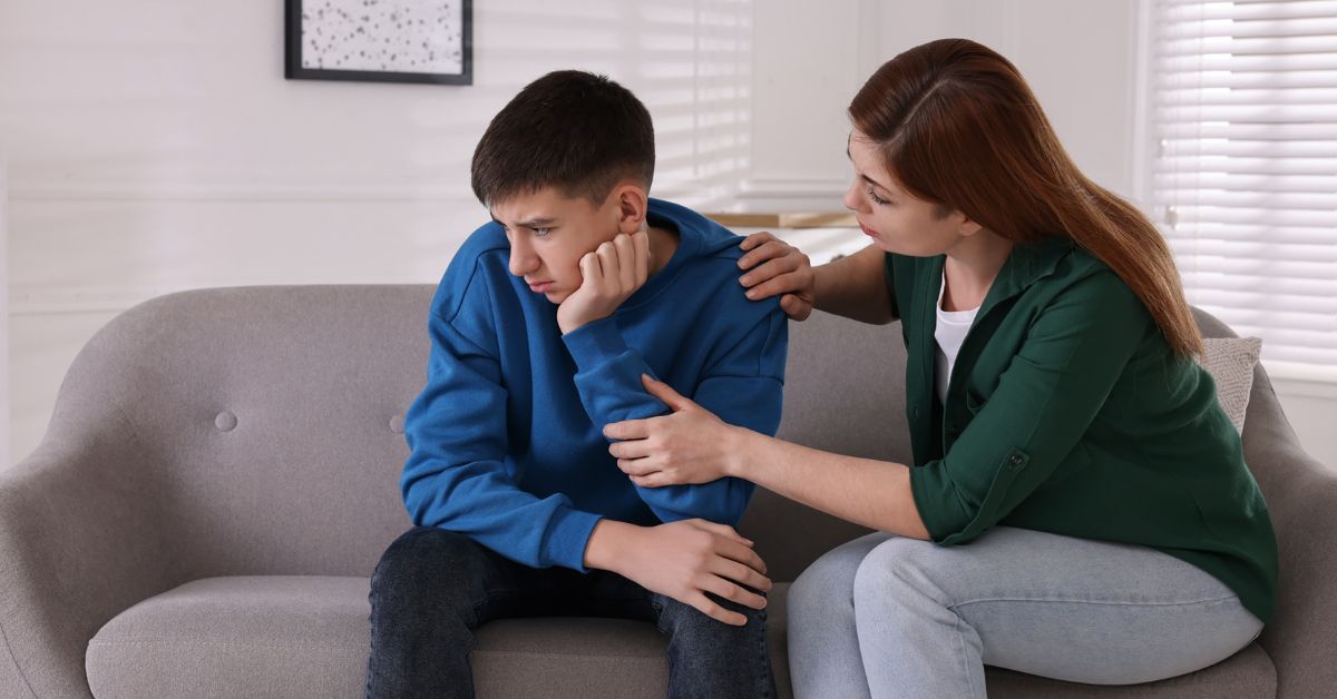 A mother is sitting on a couch with her son, emphasizing the importance of early intervention in preventing drug abuse.
