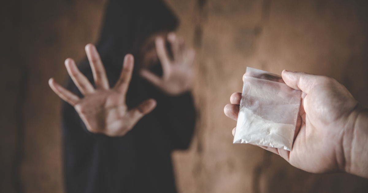 Teenager rejecting a package of drugs, preventing drug abuse among youth