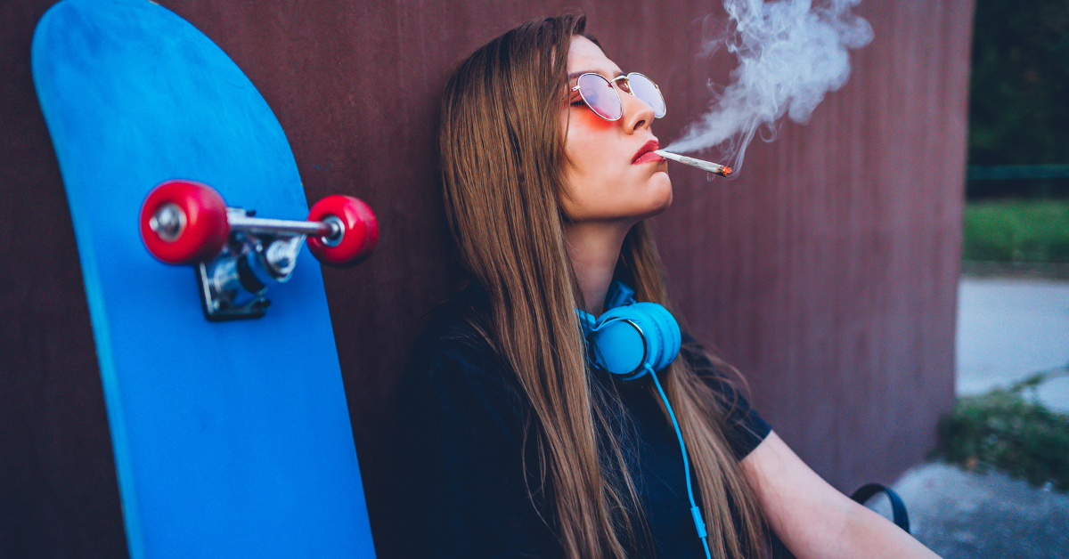 A girl leaning against a skateboard while smoking a marijuana might prompt you to wonder, "how to tell if your kid is high."