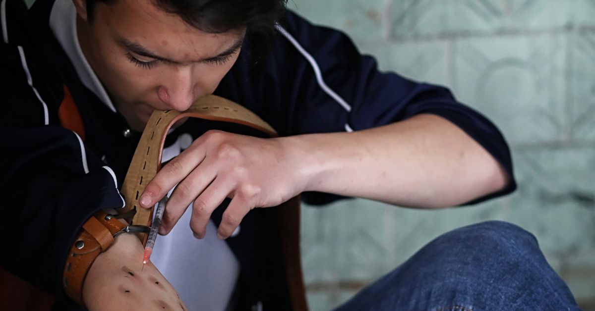 A teenager using drugs, showing signs of teenage drug use