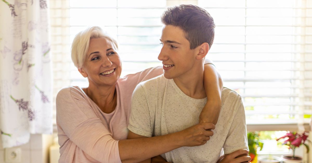 A man and his mother hugging in the kitchen, symbolizing their journey of overcoming addiction or obsession together.