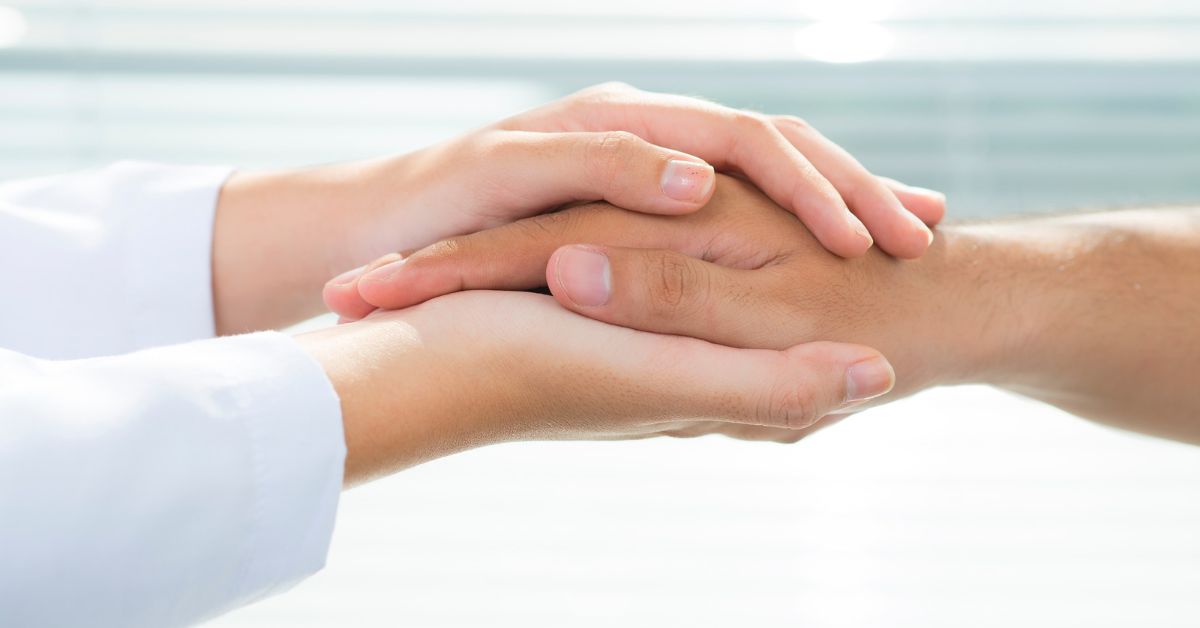 A doctor and patient shaking hands in front of a white background, discussing how to overcome addiction. 