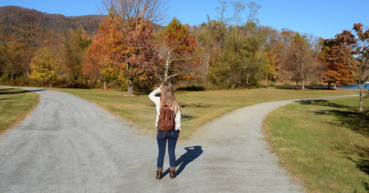 A woman is walking down a path, emphasizing the importance of accountability in addiction recovery.