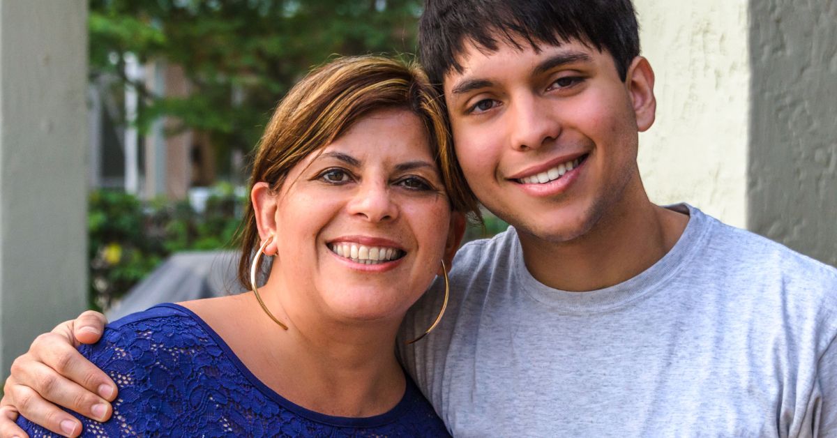 A man and his mother harnessing the power of an accountability partner in recovery while posing for a photo.