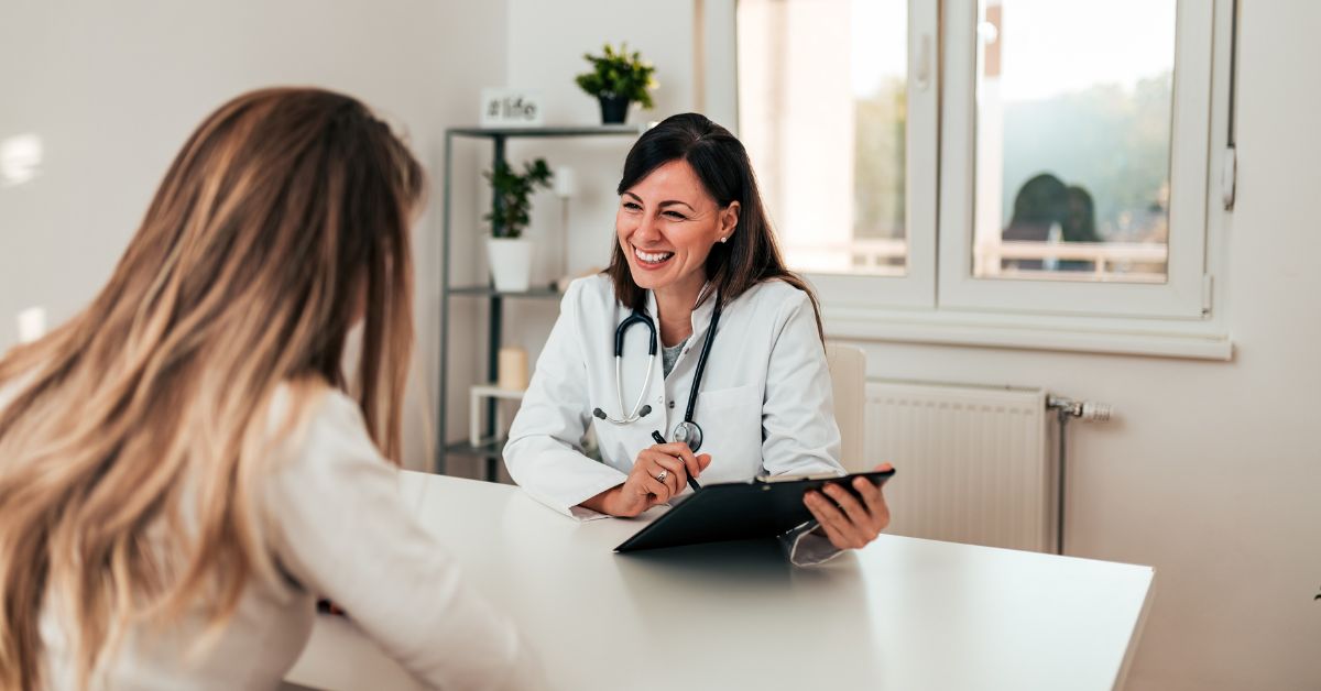 A doctor is discussing what happens when someone relapses in IOP with a patient at a desk.