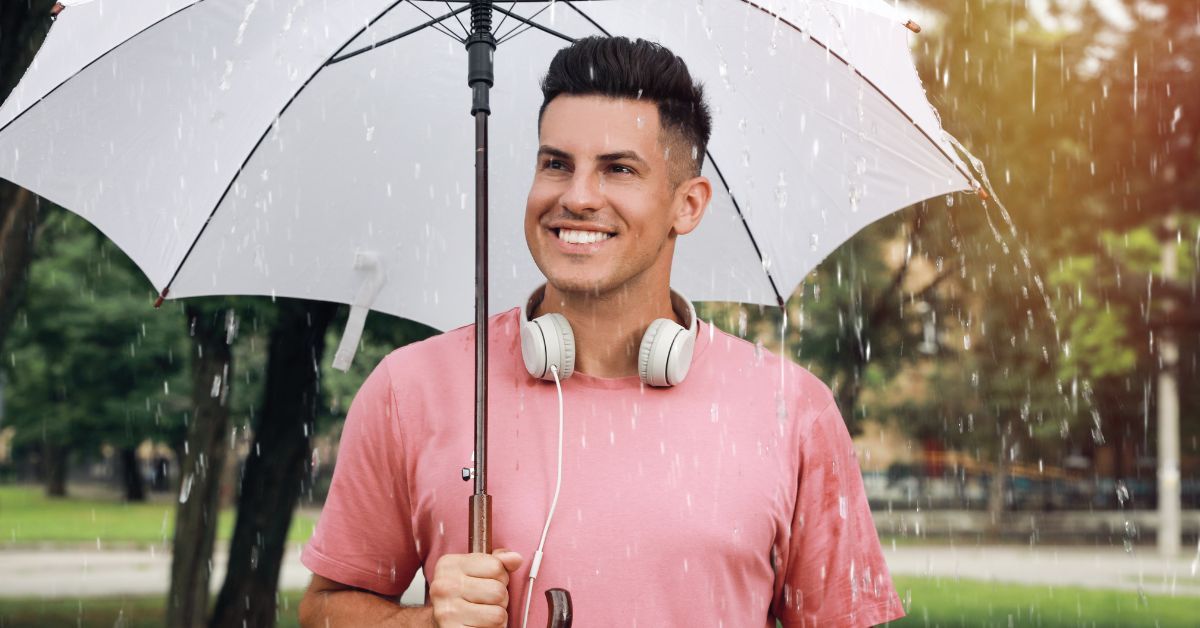 A man under an umbrella in the rain thinking why is resilency important in recovery